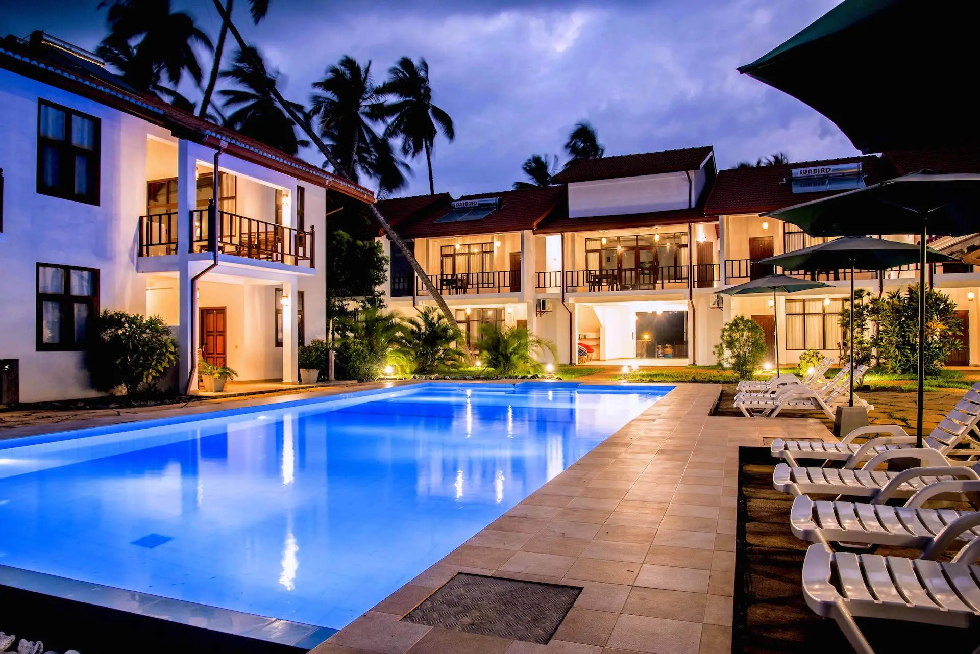 Green Parrot Beach Resort in the evening: lit terraces and the swimming pool